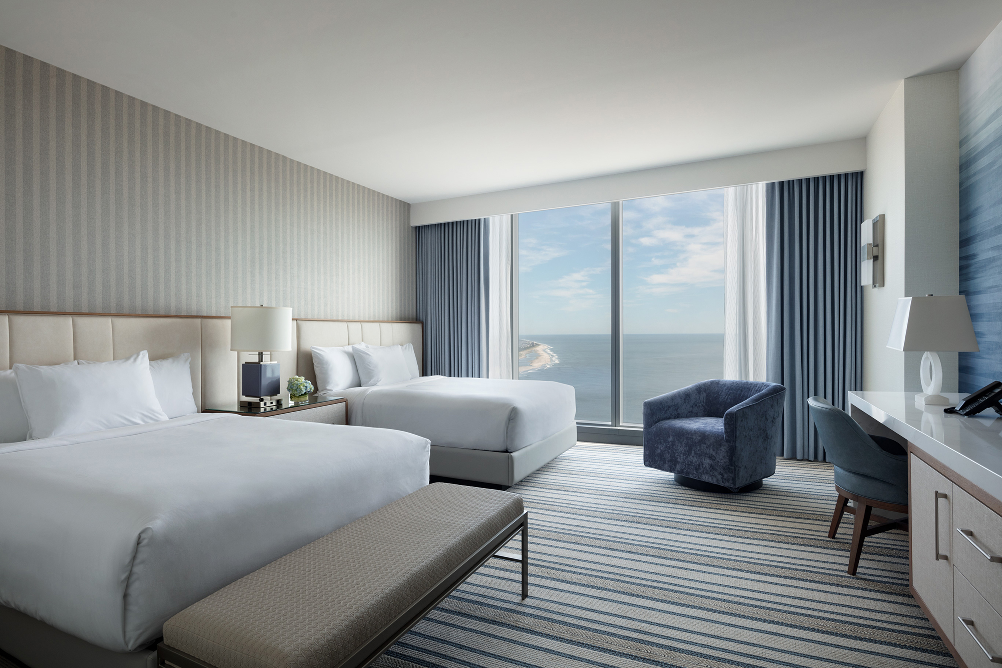 Ocean Casino Resort guest room with two queen beds and floor-to-ceiling windows overlooking the Atlantic Ocean, offering a comfortable stay for sports fans visiting Atlantic City.