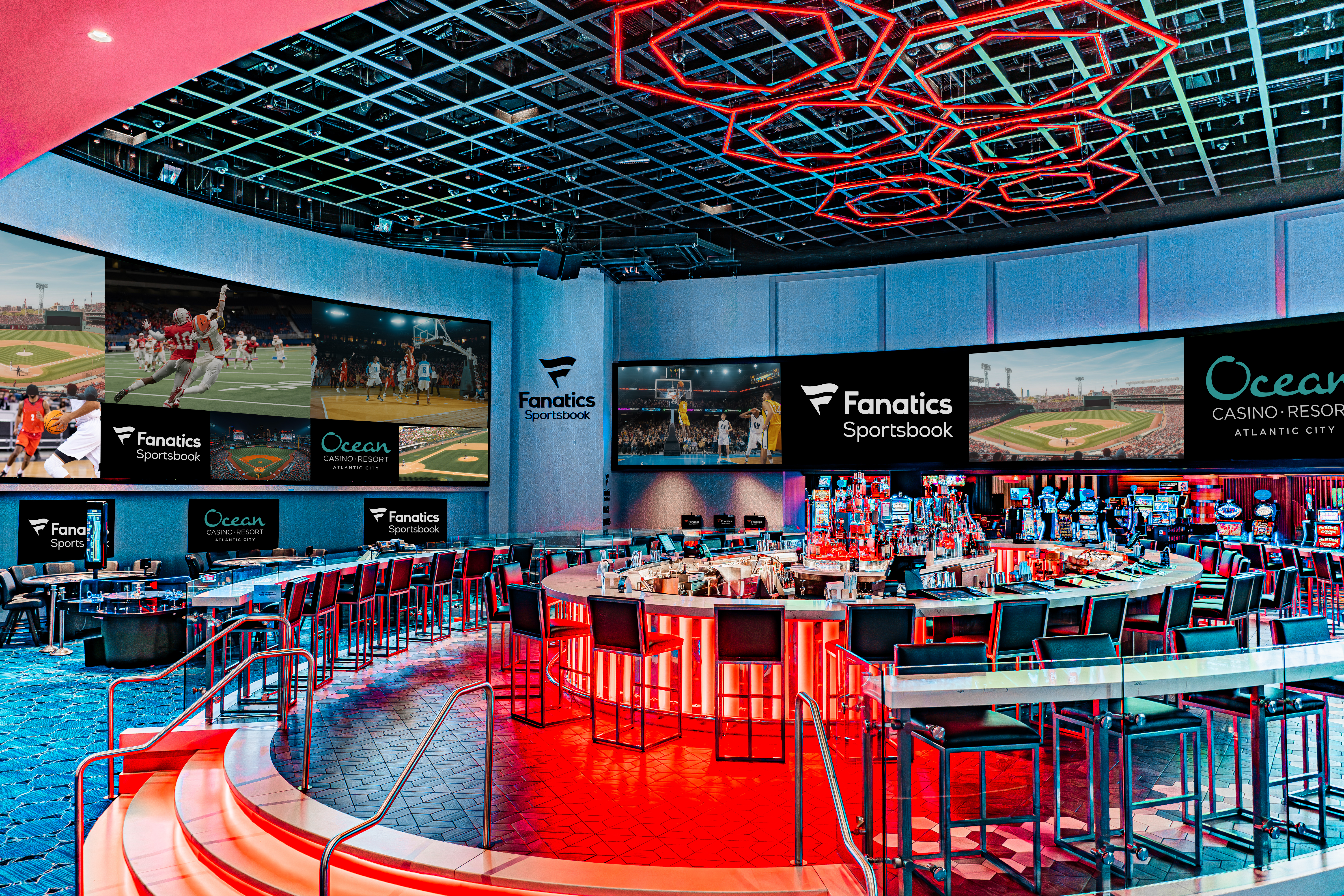 Wide view of Fanatics Sportsbook Gallery at Ocean Casino Resort with a central circular bar, stadium-style screens, and immersive sports viewing experience.