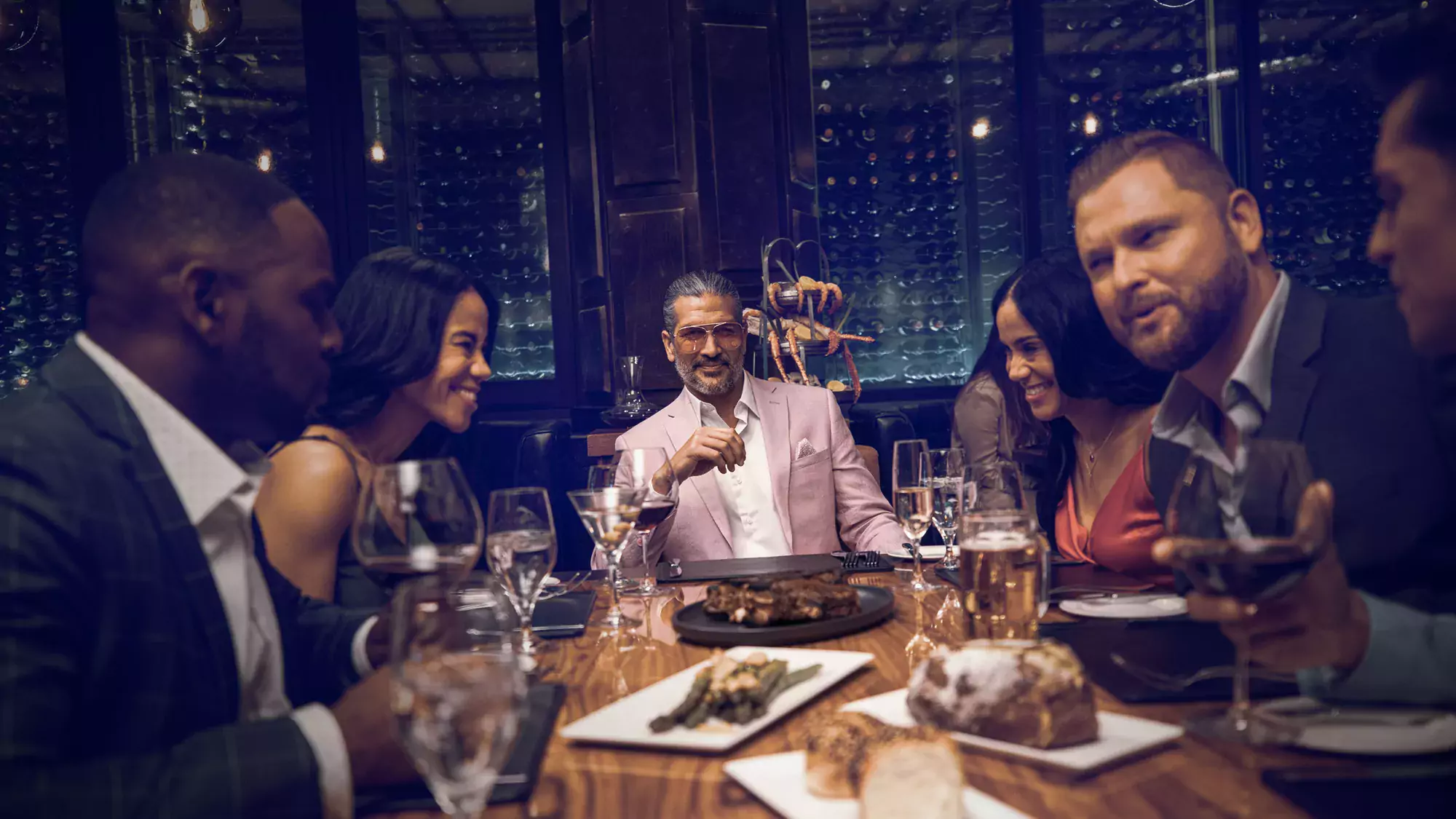 a group of adults having a steak dinner