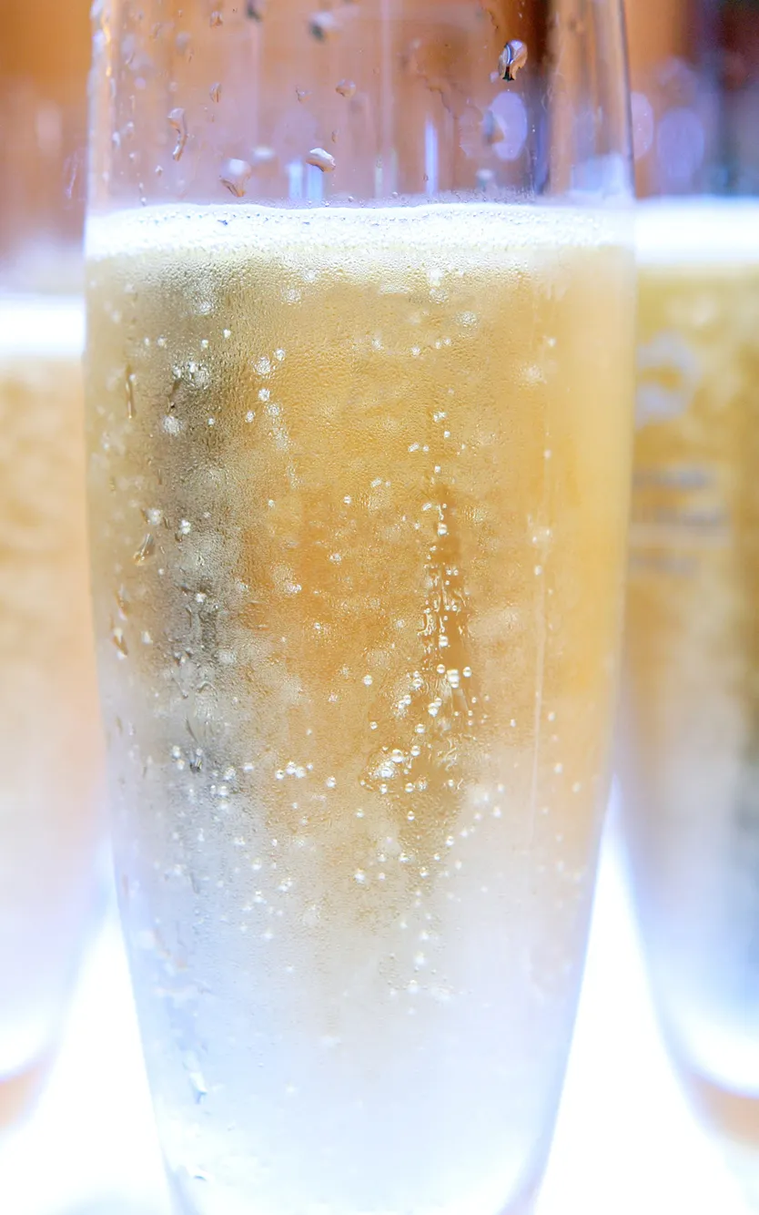 Chilled champagne flutes filled with sparkling wine, ready for a New Year’s Eve toast.