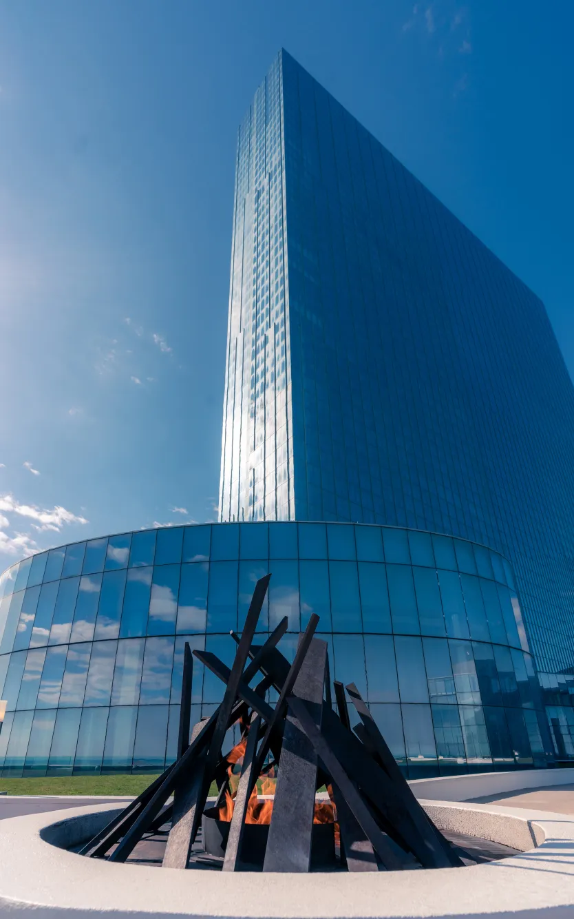 Exterior view of Ocean Casino Resort with a modern glass tower and outdoor fire feature on a clear winter day