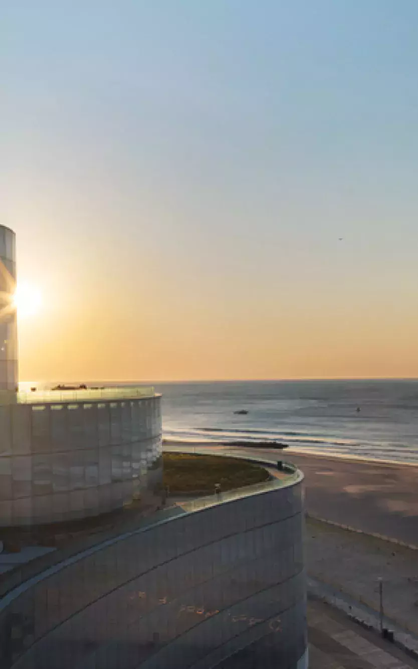 The exterior of Ocean Casino Resort and "The Arc" logo