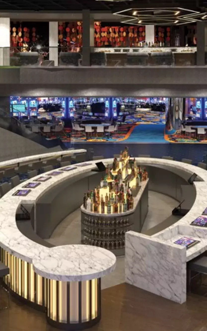 High-level view of The Gallery sports-betting venue with gaming tables, big screens and lounge areas
