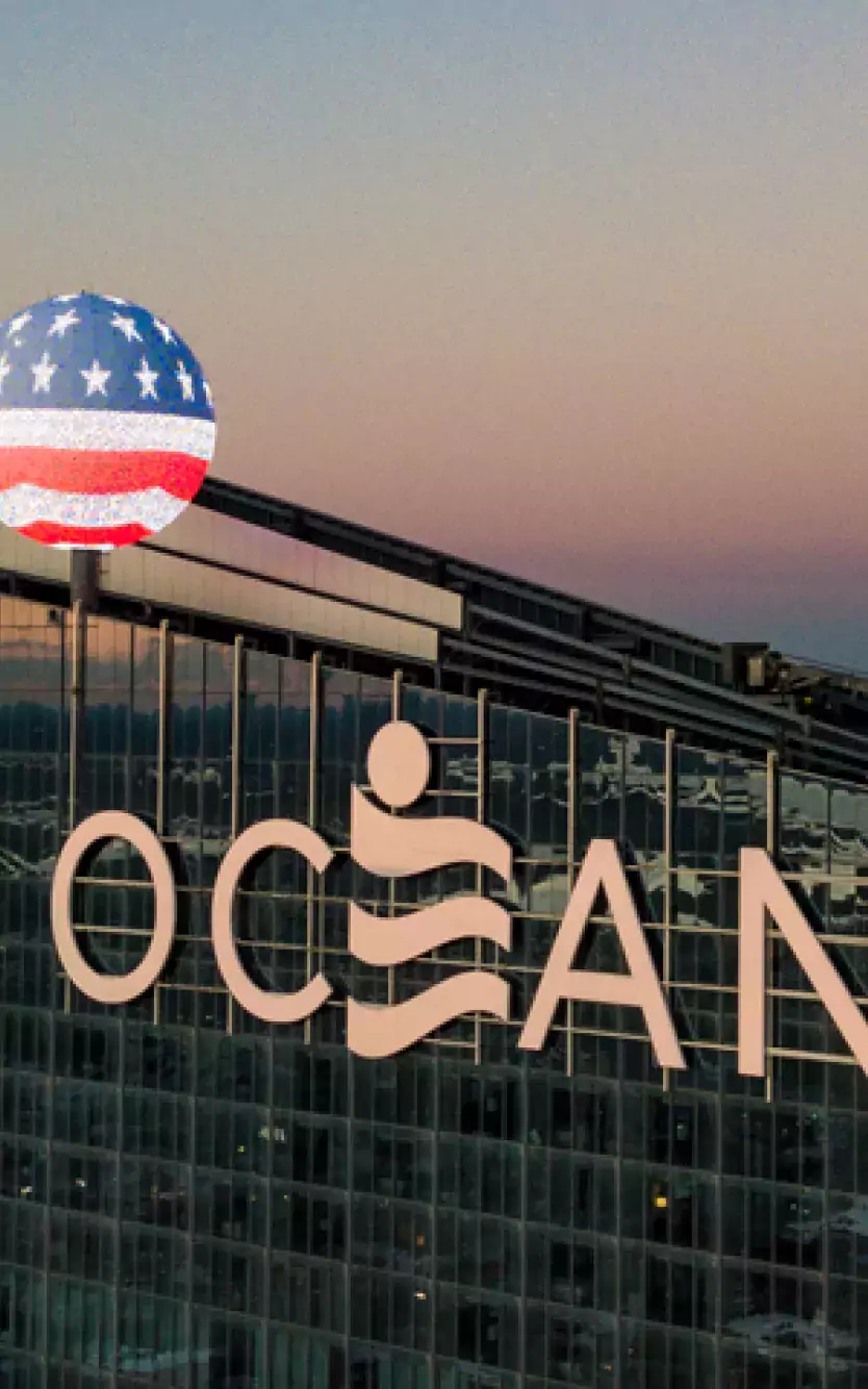top of exterior of Ocean Casino Resort with American flag overlay in honor of Veteran's Day