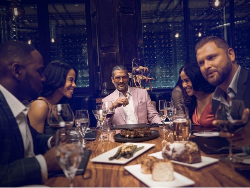 Group of five friends at the dinner table