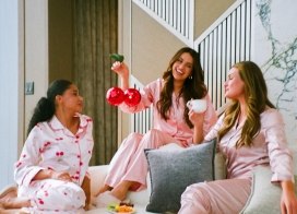 Friends celebrating a cozy Friendsgiving getaway at Ocean Casino Resort, relaxing in pajamas inside a stylish suite.